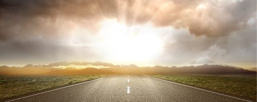 asphalt-road-with-green-grass-mountain-view