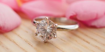 jewelry-diamond-ring-wood-table-with-beautiful-pink-rose-petal-background-close-up-01