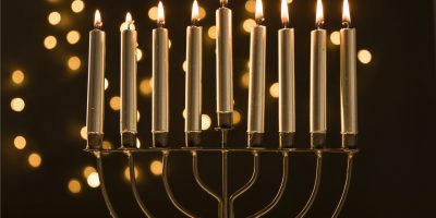 menorah-with-candles-near-abstract-garland-lights